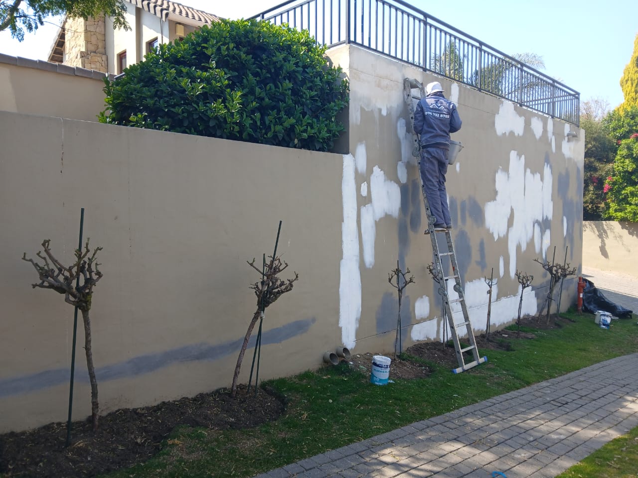 Boundary wall being prepped and patched by the JMProjects team